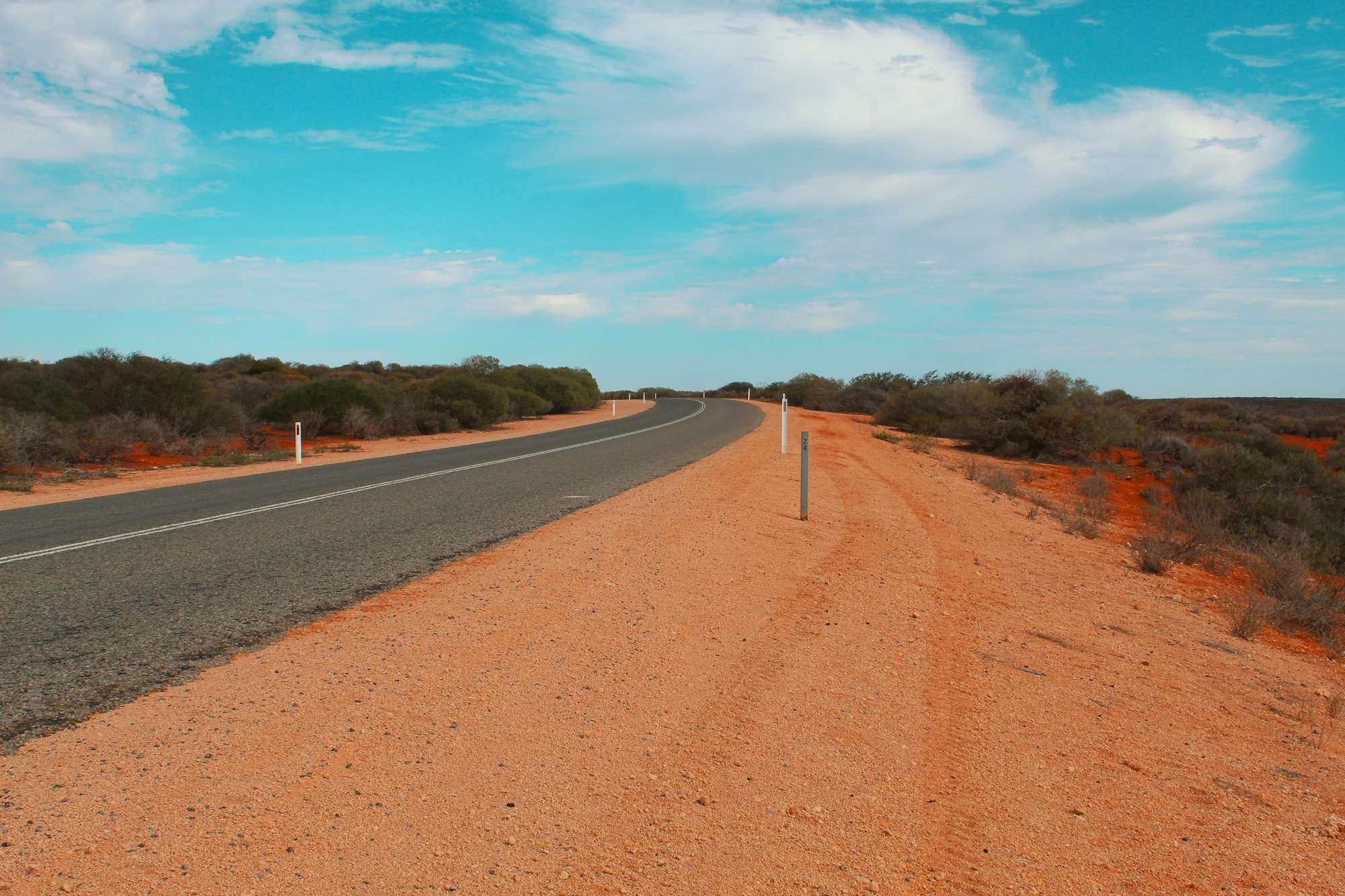 An empty road through red desert